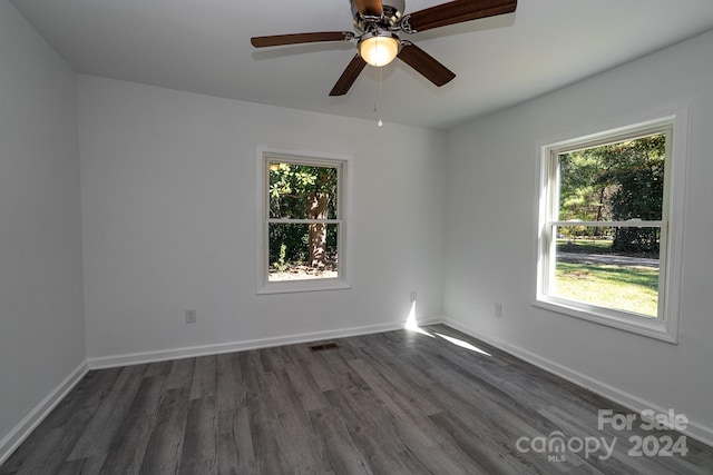 spare room featuring ceiling fan and dark hardwood / wood-style flooring