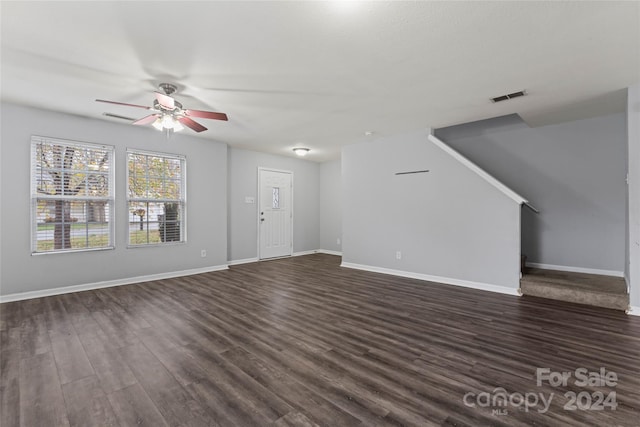 unfurnished living room with dark hardwood / wood-style floors and ceiling fan