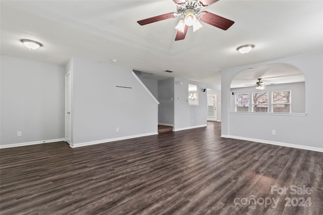 unfurnished living room featuring dark hardwood / wood-style floors and ceiling fan