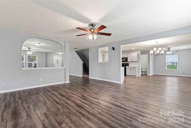 unfurnished living room with dark hardwood / wood-style flooring and an inviting chandelier