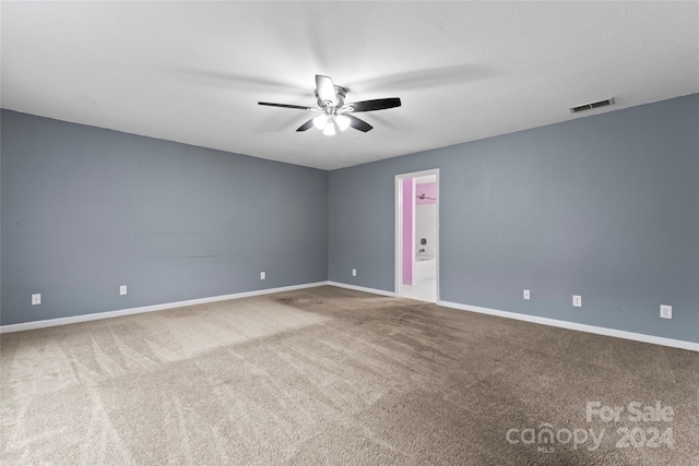 empty room featuring ceiling fan and carpet floors