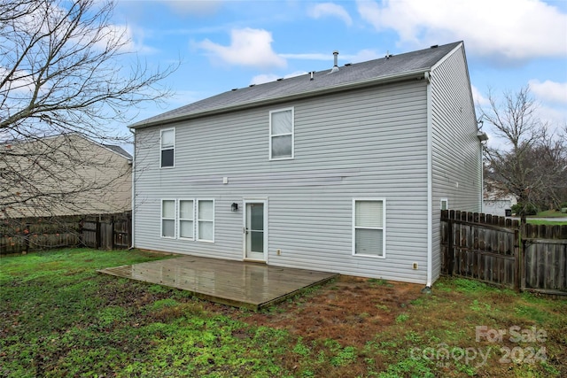 back of property featuring a lawn