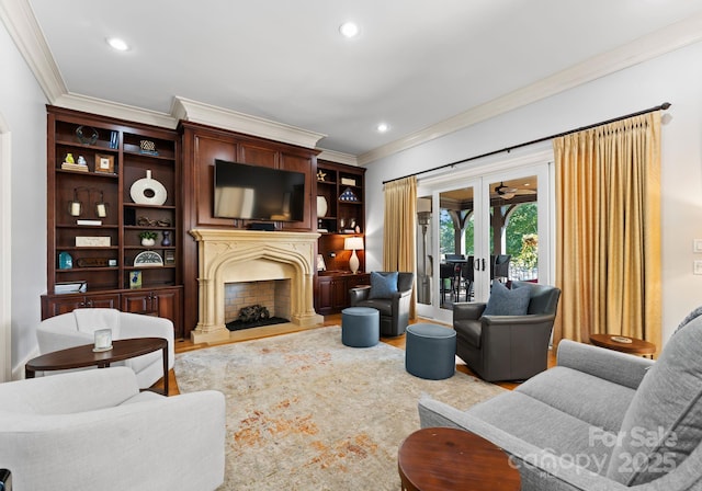 living room featuring light hardwood / wood-style floors, french doors, and crown molding