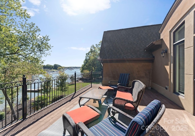 view of patio / terrace featuring a balcony and a water view