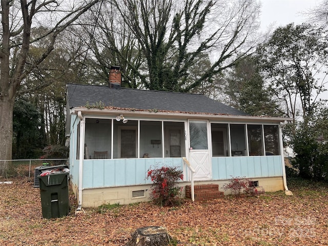 view of front facade with a sunroom