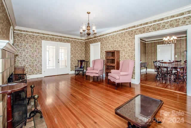 interior space with ornamental molding, french doors, hardwood / wood-style floors, and a chandelier