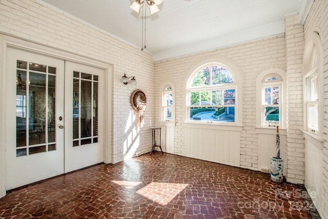 unfurnished sunroom with french doors and ceiling fan