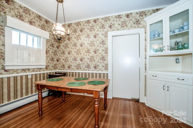 dining space with dark wood-type flooring, ornamental molding, and baseboard heating