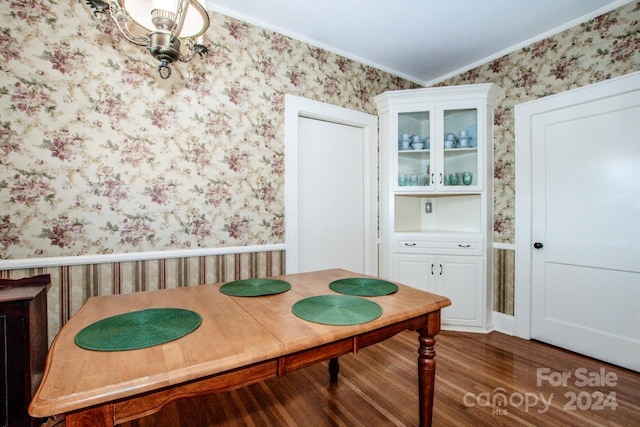 dining room with ornamental molding and dark hardwood / wood-style floors