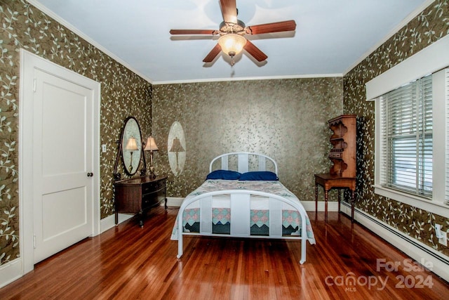 bedroom with crown molding, baseboard heating, wood-type flooring, and ceiling fan