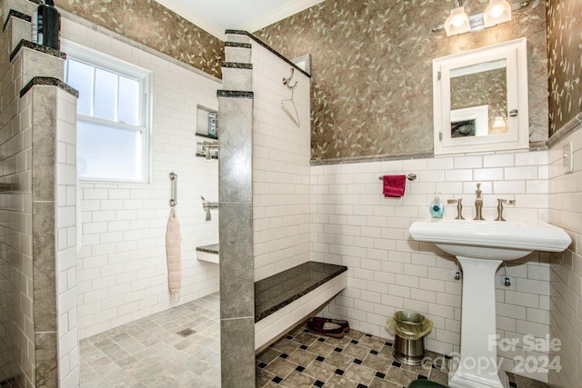 bathroom with a tile shower and tile walls