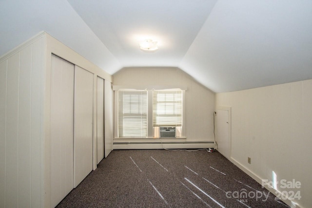 bonus room featuring cooling unit, lofted ceiling, a baseboard heating unit, and dark carpet