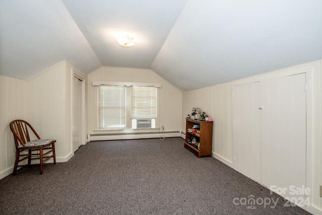 additional living space with dark colored carpet, cooling unit, a baseboard heating unit, and vaulted ceiling