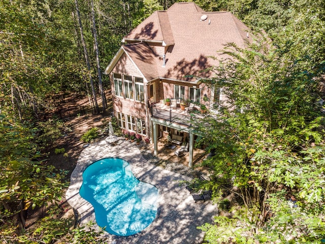 view of pool featuring a patio area and a sunroom