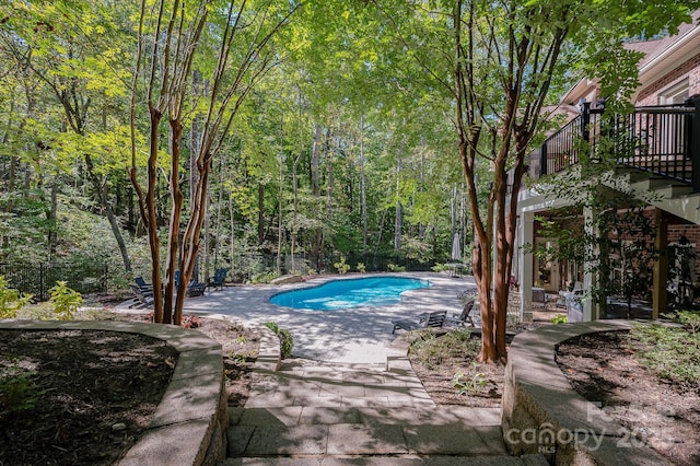 pool with a patio and stairs