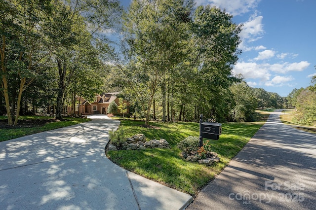 exterior space with a front yard and concrete driveway