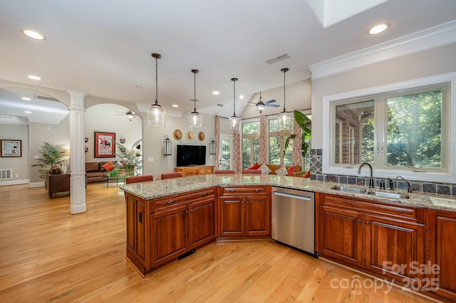 kitchen featuring a sink, visible vents, open floor plan, dishwasher, and ornate columns