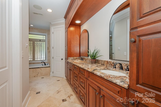 bathroom with double vanity, recessed lighting, visible vents, a sink, and a bath