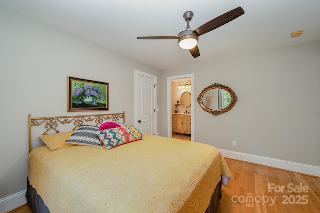 bedroom featuring ceiling fan, connected bathroom, baseboards, and wood finished floors