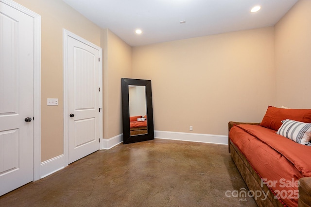 sitting room with recessed lighting, concrete floors, and baseboards