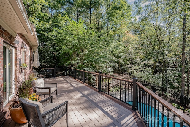 wooden deck featuring a fenced in pool