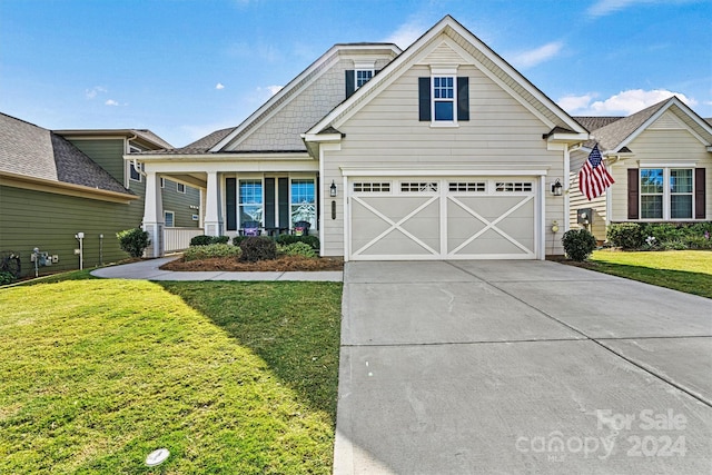 view of front of house with a front yard and a garage