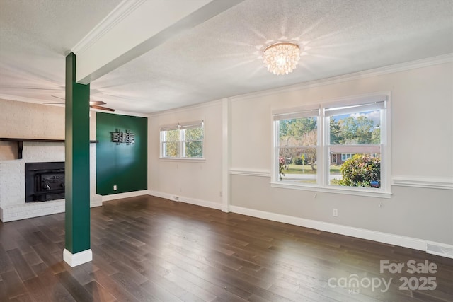 unfurnished living room featuring ceiling fan with notable chandelier, crown molding, dark hardwood / wood-style floors, and a textured ceiling