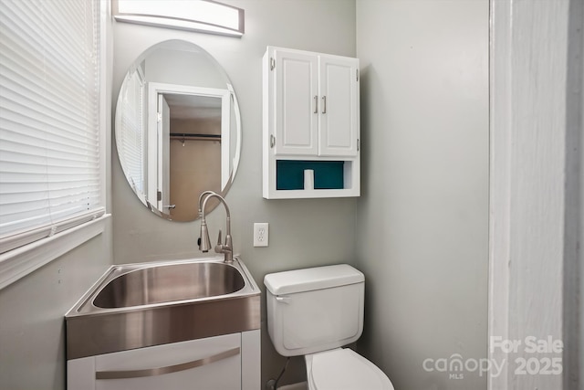 bathroom featuring toilet and vanity