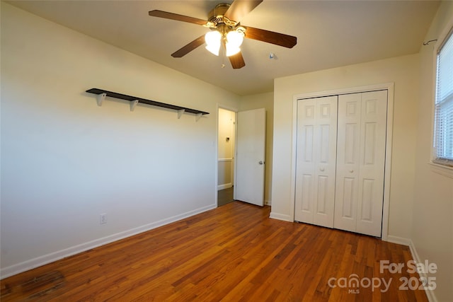 unfurnished bedroom with ceiling fan, hardwood / wood-style floors, and a closet