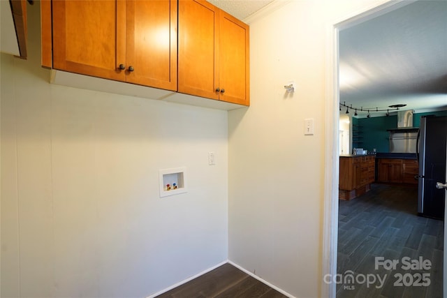 clothes washing area featuring hookup for a washing machine, cabinets, a textured ceiling, and dark hardwood / wood-style flooring