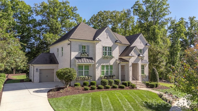 view of front of house featuring a front yard and a garage