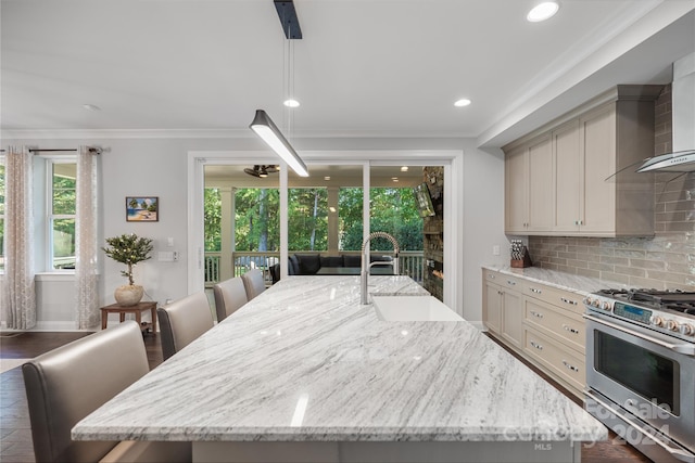 kitchen with an island with sink, backsplash, dark wood-type flooring, light stone counters, and double oven range