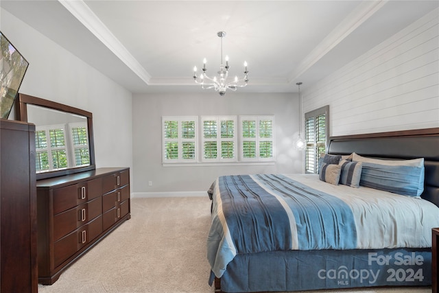 bedroom featuring light carpet, multiple windows, a chandelier, and a tray ceiling