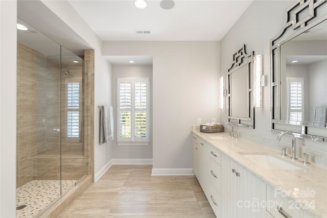 bathroom with vanity, hardwood / wood-style floors, and a shower with door