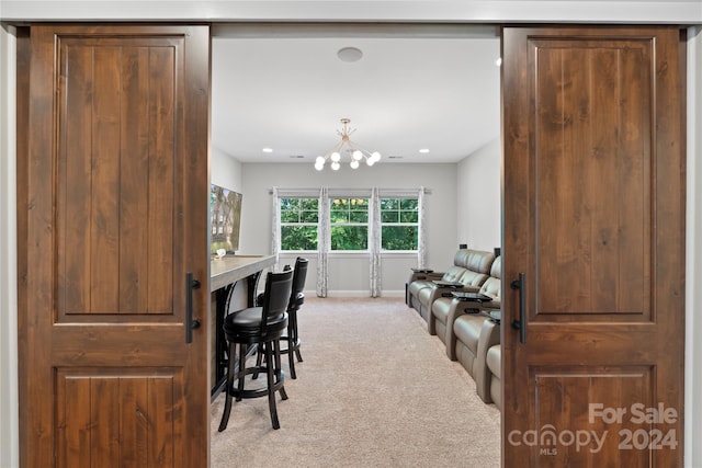 carpeted dining area with a chandelier