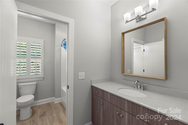 full bathroom with  shower combination, vanity, hardwood / wood-style floors, and toilet