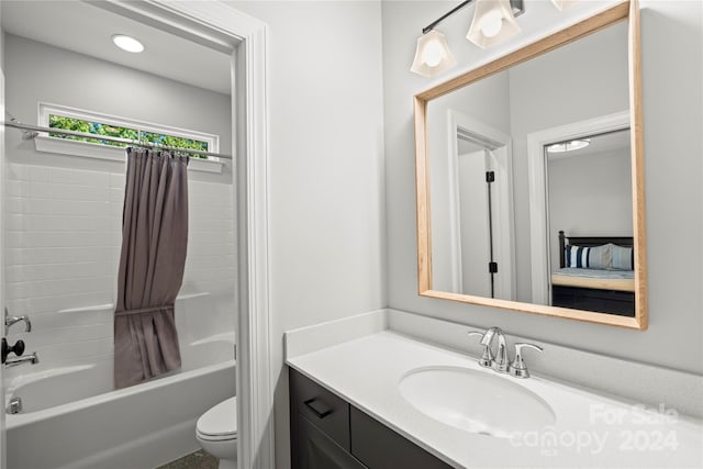 full bathroom featuring vanity, shower / bath combo with shower curtain, and toilet