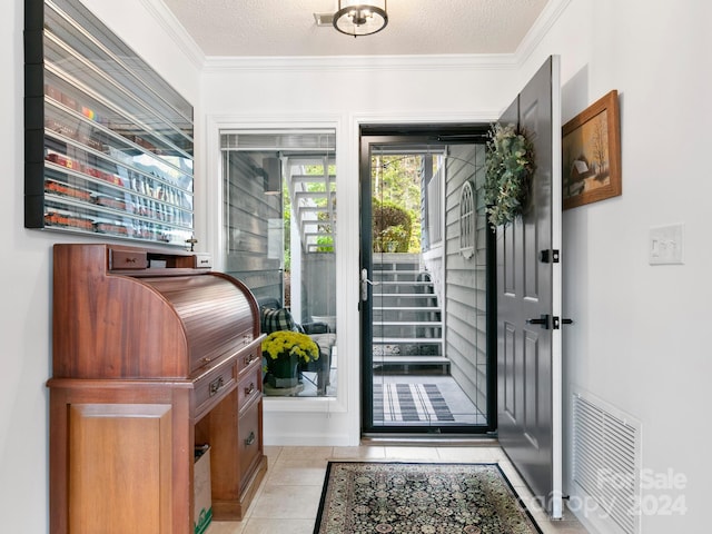 doorway with light tile patterned floors, a textured ceiling, and crown molding