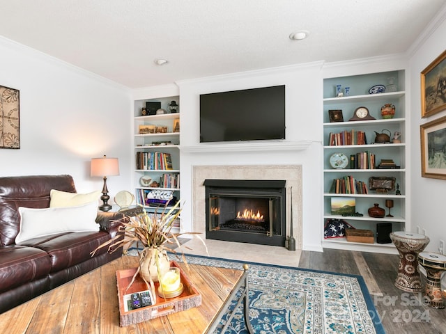 living room with wood-type flooring, a textured ceiling, built in features, and ornamental molding