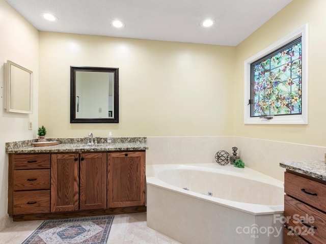 bathroom featuring tile patterned flooring, vanity, and a bathtub