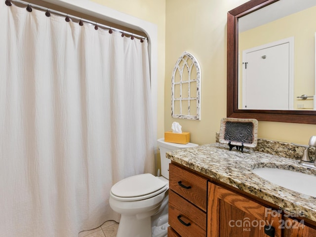 bathroom with tile patterned floors, vanity, and toilet