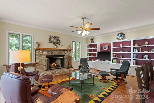 living room with light hardwood / wood-style floors, crown molding, and plenty of natural light