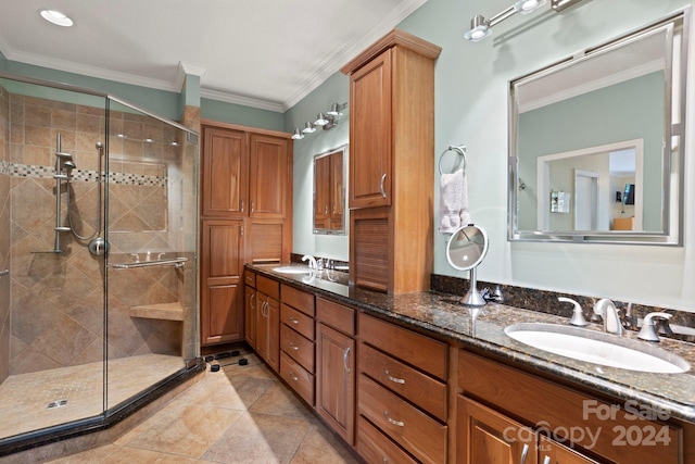 bathroom featuring vanity, an enclosed shower, tile patterned floors, and crown molding