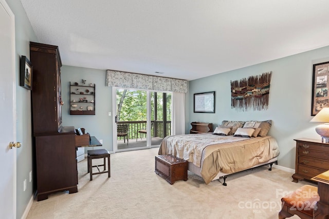 carpeted bedroom with a textured ceiling and access to outside