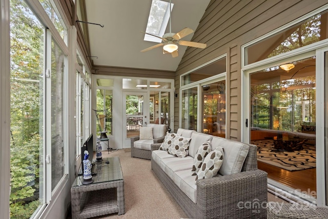 sunroom / solarium featuring lofted ceiling with skylight and ceiling fan