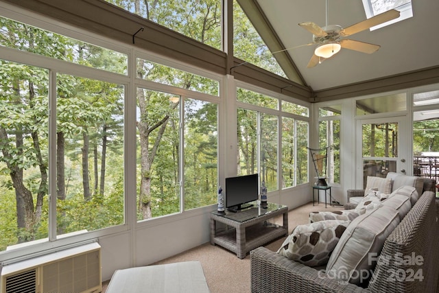 sunroom / solarium featuring an AC wall unit, lofted ceiling, and ceiling fan