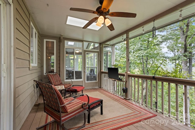 sunroom with ceiling fan and a skylight