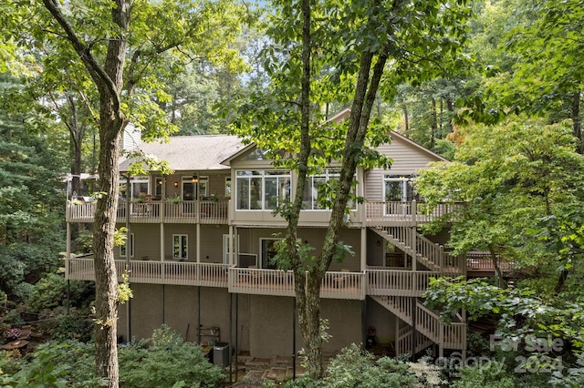 back of house featuring central AC and a wooden deck