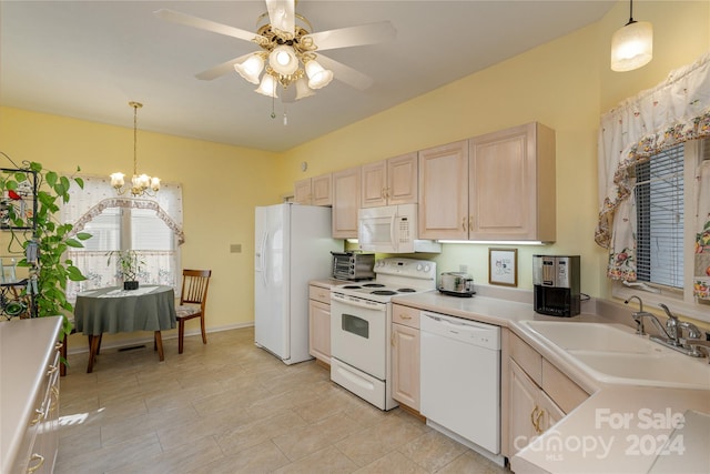 kitchen featuring light brown cabinets, sink, hanging light fixtures, and white appliances