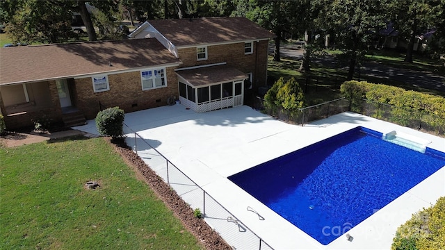 exterior space featuring a fenced in pool, a patio, a front lawn, and a sunroom